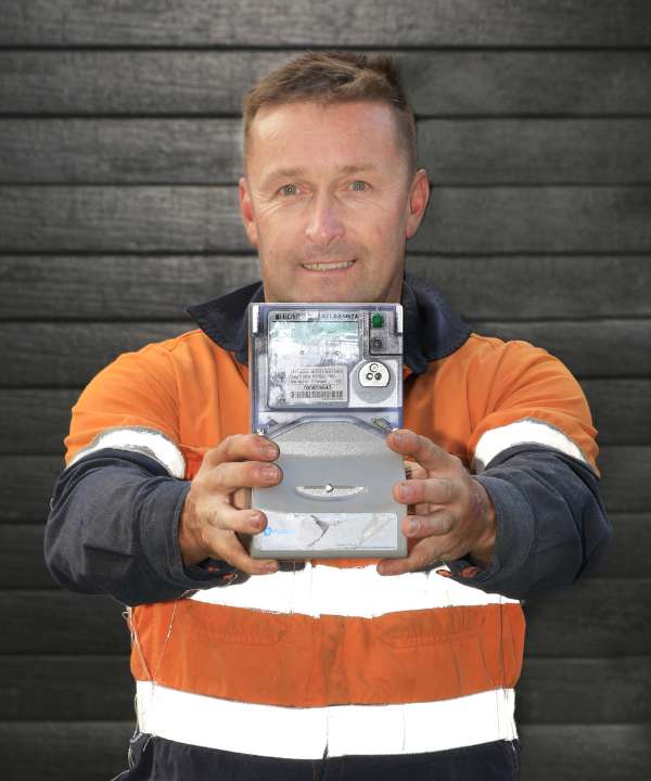 Level 2 electrician holding a smart meter